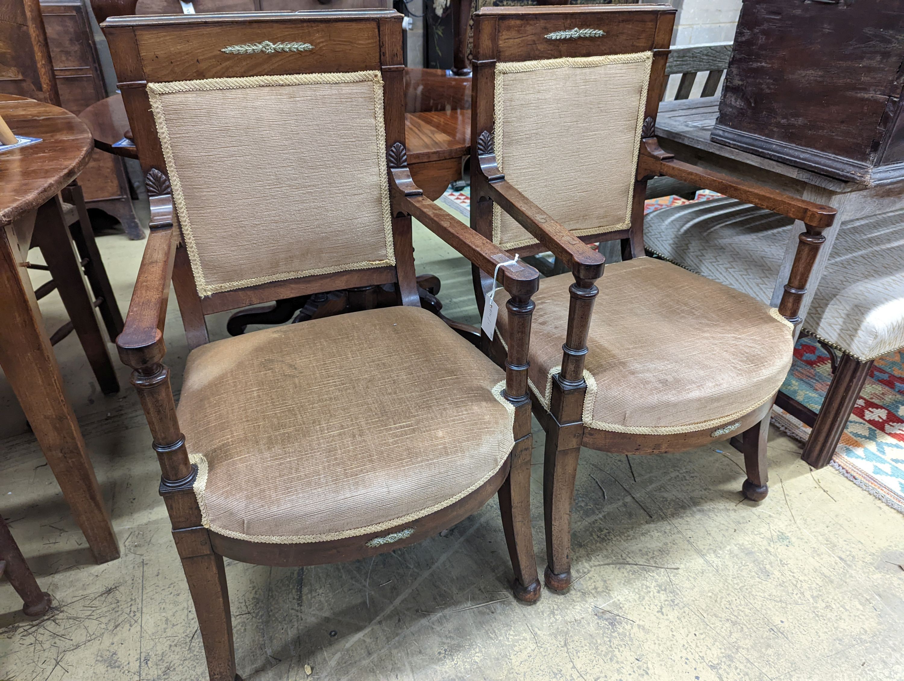 A pair of French Empire style mahogany gilt metal mounted elbow chairs, width 54cm, depth 50cm, height 96cm